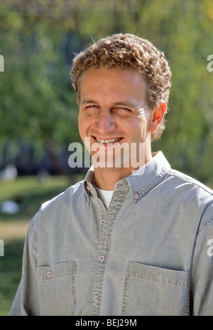 curly blond hair friendly warm pleasant inviting pleasant good-looking handsome male man 20's Stock Photo