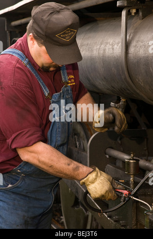 Engineer oiling a steam engine in a heritage museum Stock Photo - Alamy