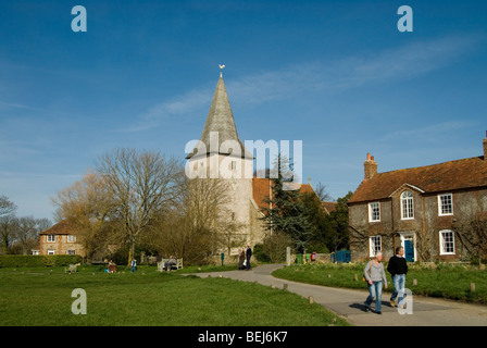 Bosham church on a sunny day with people walking and sitting Stock Photo