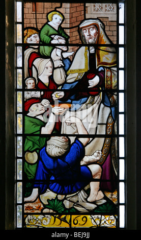 A stained glass window depicting the giving of money to beggars and lepers, St Mary Magdalene Church, Warham, Norfolk, possibly 16th century German Stock Photo