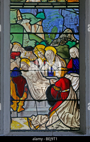 Detail of the medieval stained glass window depicting the entombment of Jesus Christ, St Mary Magdalene Church, Warham, Norfolk, possibly 16th century Stock Photo