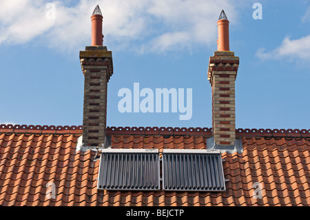 Evacuated solar energy tubes fitted to the rooftop of a house in Suffolk, UK. Stock Photo