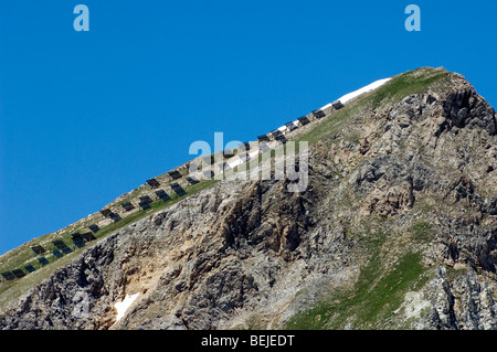 Buttresses / snow fences on mountain slope to avoid avalanches in the Alps, France Stock Photo