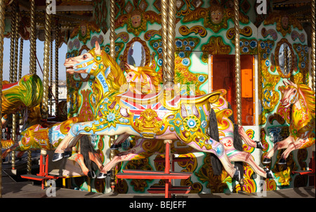 Colourfully painted horses on a fairground carousel Stock Photo