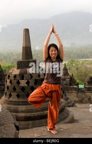 woman doing yoga at Borobudur temple, Java, Indonesia Stock Photo