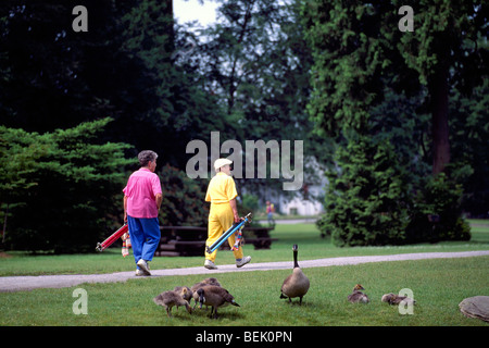 Burnaby, BC, British Columbia, Canada - Active Senior Golfers walking with Golf Clubs at Central Park Golf Course Stock Photo