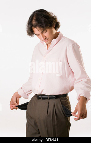 Man turning out his empty pockets Stock Photo