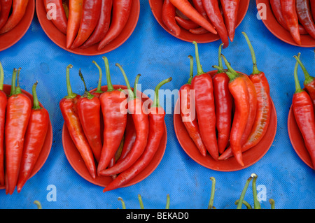 Red Hot Chili Peppers, Cayenne Peppers or Chilli Peppers in Red Bowls on Display in a Kuching Street Market Sarawak Malaysia Borneo Stock Photo
