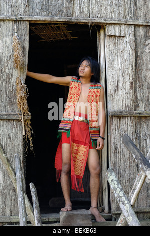 Young Man of the Iban Tribe Standing in the Doorway of a Longhouse near Kuching Sarawak Malaysia Borneo Stock Photo