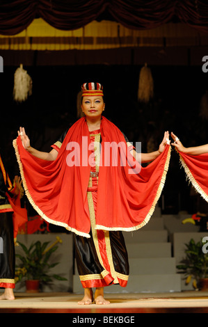 Woman of Bidayuh Tribe in Red Costume Dancing the Harvest or Bird Dance Sarawak Cultural Village Kuching Sarawak Malaysia Borneo Stock Photo