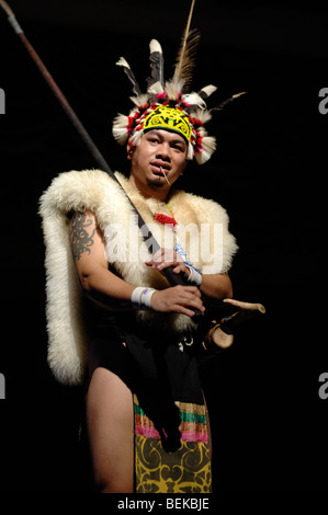 Warrior from the Orang Ulu Tribe in Feathered Head-dress & Animal Skins with Blowpipe Dance Sarawak Malaysia Borneo Stock Photo