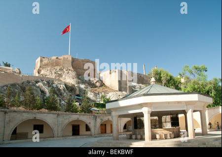 View from the court of Yeni Dergah Mosque to the citadel in Urfa, Turkey Stock Photo