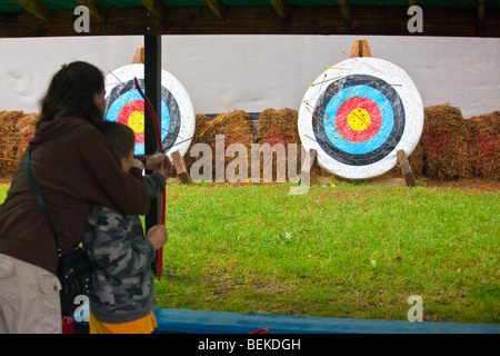 Mother Teaching Son Archery at the Renaissance Fair in Tuxedo, New York Stock Photo