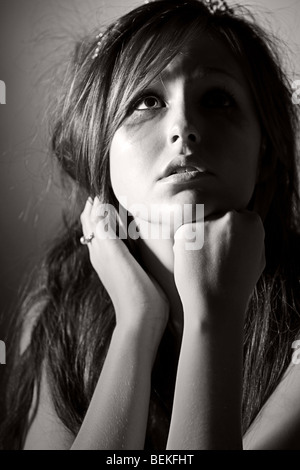 Powerful Low Key Shot of a Beautiful Teenage Girl Looking Up Stock Photo