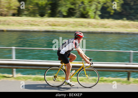 Senior bicyclist on road bike. Blurred background. Copy space Stock Photo