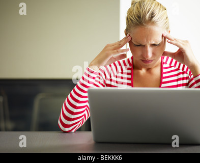 woman having headache with hands on temple. Copy space Stock Photo