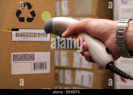 A man gets on the hip reader in operations directed on printed barcode. Warehouse scene. Stock Photo