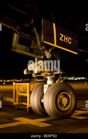 The giant nose wheel of a Boeing 747-400 airliner is parked on the apron area during its overnight turnaround, Heathrow Airport Stock Photo