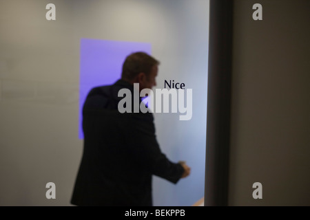 After an internal meeting a male employee is ready to leave a small conference room at the British Airways' corporate HQ. Stock Photo