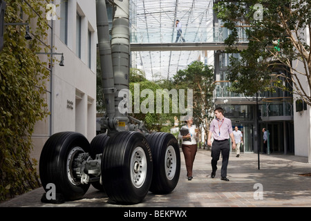 Two employees walk through the bright atrium at the British Airways' corporate headquarters at Waterside near Heathrow airport. Stock Photo