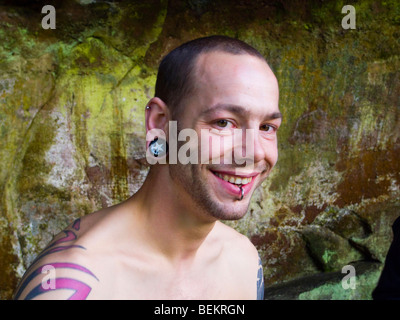 Portrait of a smiling tattooed and pierced male climber whilst out climbing Stock Photo