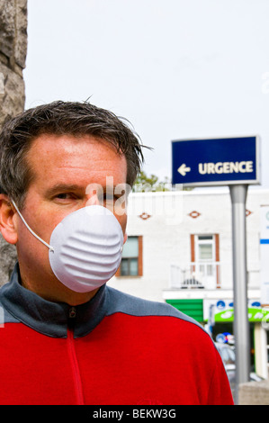 Man standing in front of hospital Stock Photo