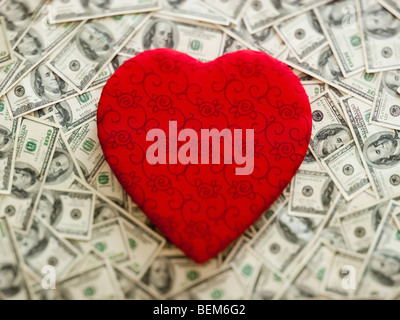 Symbolic red heart wtih US dollars as background Stock Photo