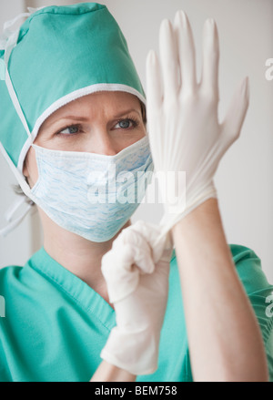 Female doctor putting on gloves Stock Photo