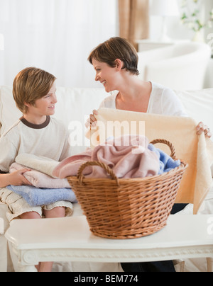 Mother and child folding laundry Stock Photo