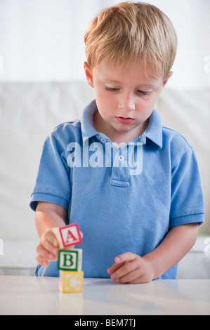 Child playing with ABC blocks Stock Photo