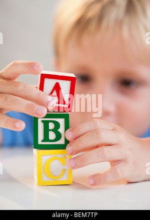 Child playing with ABC blocks Stock Photo