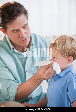 Father wiping child's nose Stock Photo