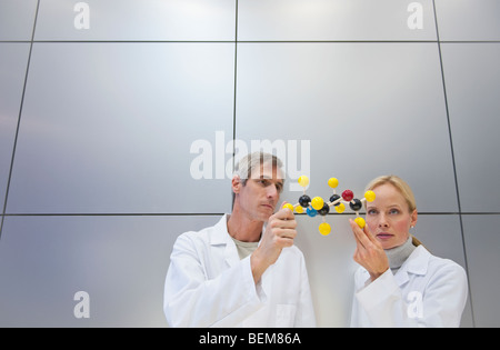 Reseachers holding molecular model Stock Photo
