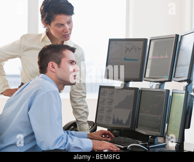 Traders studying computer screens Stock Photo