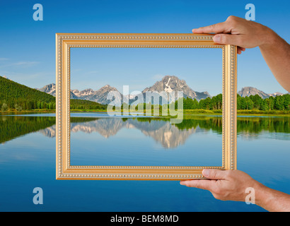Picture frame held up to scenic view Stock Photo