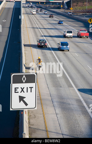 A carpool only exit sign on Highway 405 with cars driving in background. Bellevue, Washington, USA Stock Photo