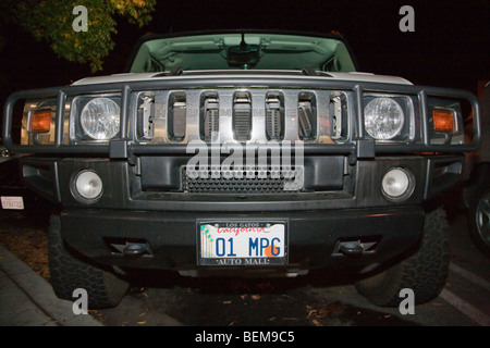 Gas guzzling Hummer H2 with a custom license plate 01 MPG (One Mile Per Gallon). Stock Photo