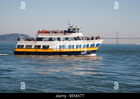 Weekend tourists on Blue & Gold Fleet ferry on San Francisco Bay. Oakland Bay Bridge Bay Bridge in the background. Stock Photo