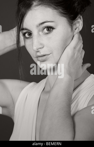 Black and White Portrait Shot of a Pretty Girl against Grey Stock Photo