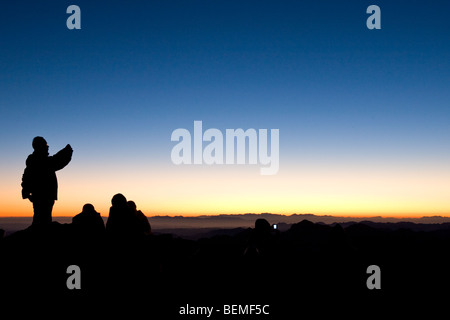 people watching sunrise at dawn after the early morning trek to Mount Sinai, Egypt, Middle East Stock Photo