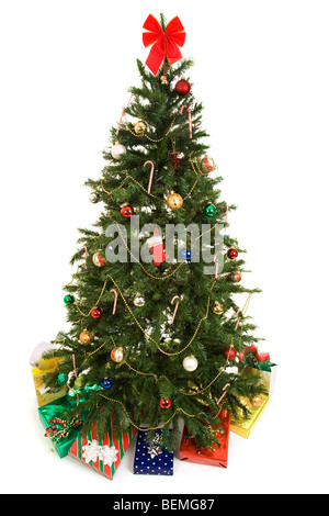 Beautiful decorated Christmas tree with colorful gifts underneath. Fully isolated on white. Stock Photo