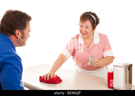 Friendly waitress cleaning the counter in a diner. White background. Stock Photo