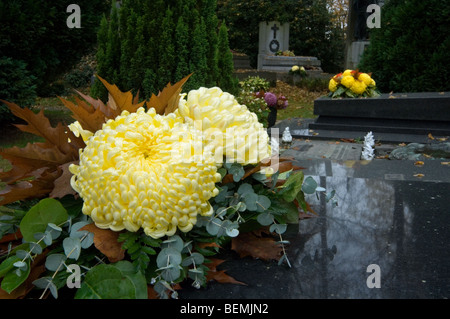 Chrysanthemum flowers and gravestones at the Western Cemetery, Ghent, Belgium Stock Photo