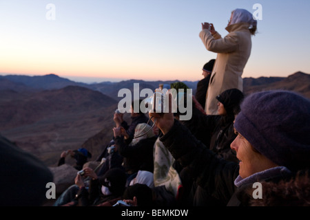 people watching sunrise at dawn after the early morning trek to Mount Sinai, Egypt, Middle East Stock Photo