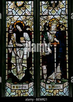 A stained glass window by J Powell & Sons depicting St Agnes and St Teresa, St Nicholas Church, Blakeney, Norfolk Stock Photo