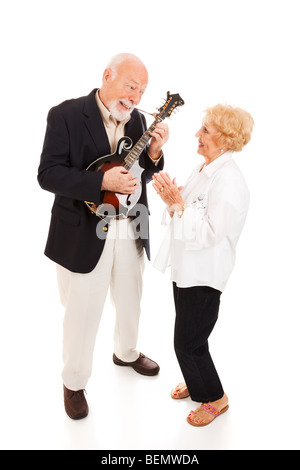 Senior man plays mandolin while his wife signs along. Full body isolated. Stock Photo
