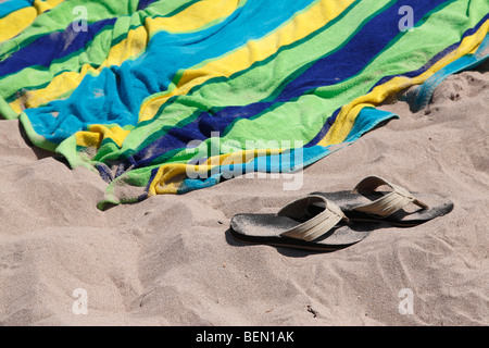 View of sand beach towel and sandals in  Michigan USA United States no not people isolated from above Stock Photo