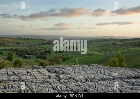 Sunset at Malham Cove, looking towards the village of Malham in the Yorkshire Dales National Park, North Yorkshire UK Stock Photo
