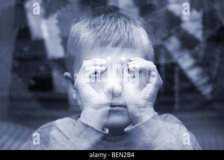 child making imaginary binoculars with hands in an ethereal double exposure Stock Photo