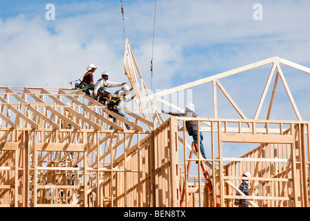 roof trusses being put in place at a construction site Stock Photo
